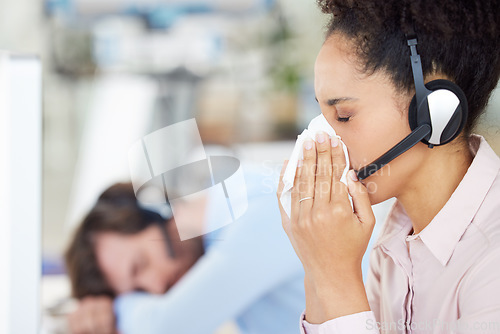 Image of Customer service, call center and sick woman blowing nose in office workplace. Covid, cold and black female telemarketing employee, sales agent or consultant with tissue for flu, corona or covid 19.