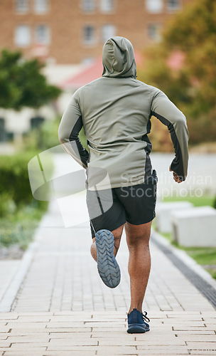 Image of Fitness, back and black man running in city in winter for health, wellness and strength. Sports, exercise and male runner training, cardio jog or exercising outdoors alone on street for marathon.