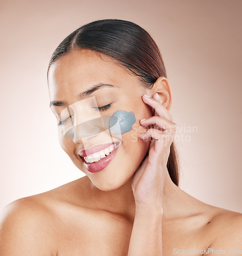 Image of Face mask, skincare and woman model in a studio for a cosmetic, wellness and natural routine. Cosmetics, beauty and female from Brazil with a charcoal facial treatment isolated by a brown background.