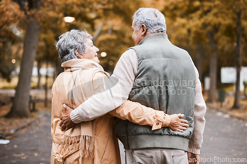 Image of Senior couple, love and health while walking outdoor for exercise, happiness and care at a park in nature for wellness. Old man and woman embrace in a healthy marriage during retirement with freedom