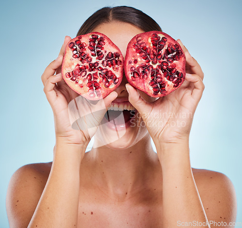 Image of Pomegranate, beauty and woman hands with natural skincare product, detox and healthy skin with vegan and organic treatment. Happy, fruit and wellness with health for body against studio background.