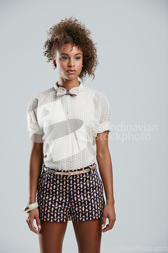 Image of Fashion, style and clothes with a model black woman in studio on a gray background to promote a clothing brand. Summer, shorts and afro with an attractive young female on space for branding