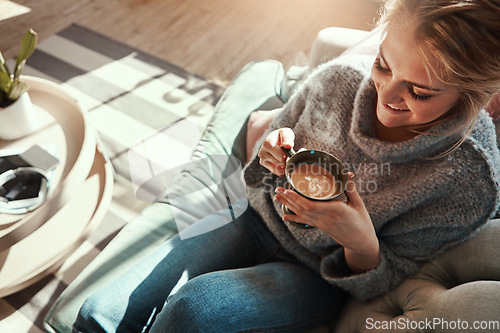 Image of Woman, coffee and relax smile on sofa in living room for calm, peace and happy quality time. Female, drinking warm tea and happiness or lifestyle wellness, morning routine and rest on couch in home