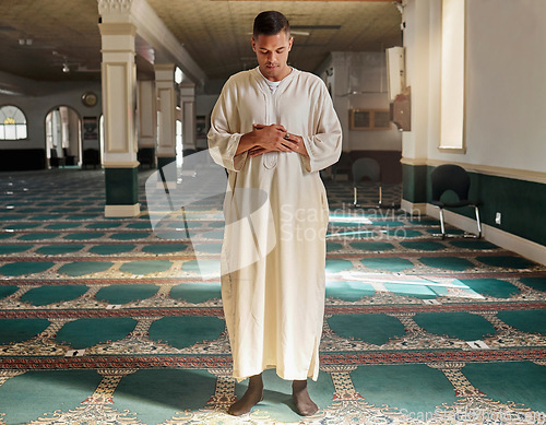 Image of Man, muslim faith and praying in mosque for God, peace and mindfulness with traditional islamic clothes. Islam worship, prayer and spiritual balance for ramadan, religion and gratitude in Doha, Qatar