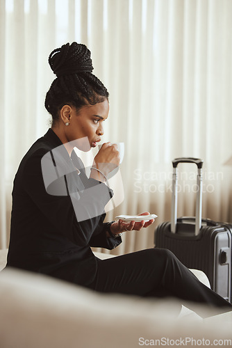 Image of Coffee, travel and luggage with a business black woman drinking a beverage in an airport departure lounge. Tea, corporate and business class with a female employee waiting in a terminal with baggage