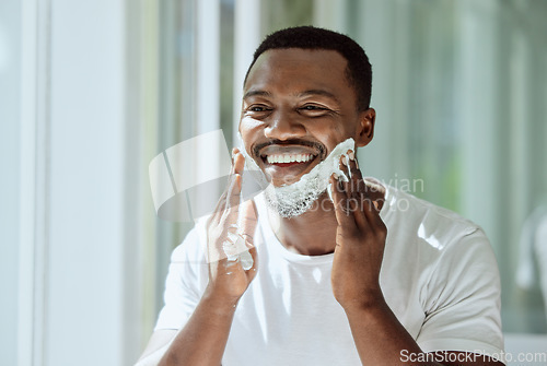 Image of Shaving, cream and black man grooming face for clean look, hygiene care and beauty morning routine in the bathroom. Skincare, happy and African person ready to shave beard and facial hair with foam