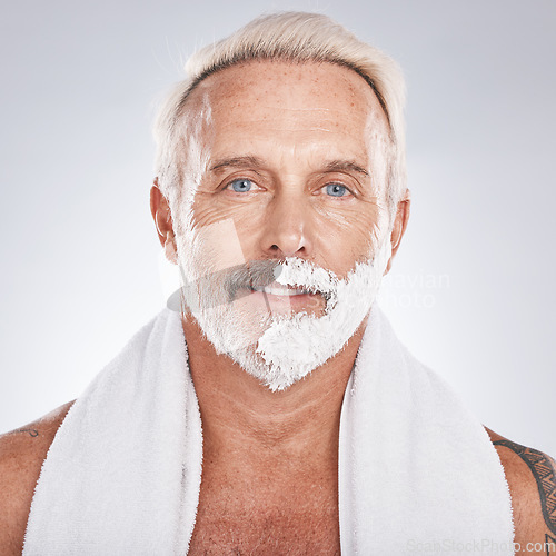 Image of Man, face and grooming shaving cream in self care maintenance or beauty aesthetic on gray studio background. Portrait, happy smile and mature model with hair removal foam in skincare facial cleaning