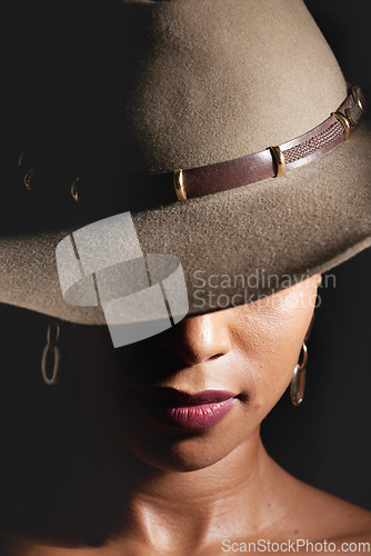 Image of Woman, dark studio and hat for fashion, beauty and mystery with style, design or closeup headshot. Girl, model and black background for fantasy, night aesthetic or makeup for edgy, sexy woman and art