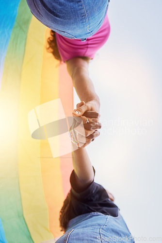 Image of LGBTQ community, rainbow flag and couple holding hands for human rights protest, solidarity and gay lesbian support. Queer, sky and black people together in love, partnership and equality below view
