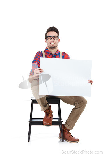 Image of Man, studio portrait and holding paper board for marketing, branding mockup and focus by white background. Young model, isolated and sitting with mock up poster, billboard and space for advertising