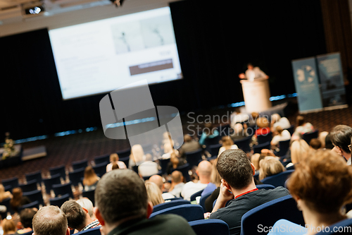 Image of Speaker giving a talk on scientific conference. Audience at the conference hall. Business and Entrepreneurship concept.