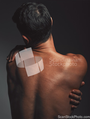 Image of Hug, self love and back of a man with creative aesthetic, self expression and body on a dark black studio background. Skin embrace, art and mysterious model with love, self care and affection