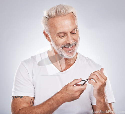 Image of Nail clippers, beauty and grooming with a man in studio on gray background mockup to pamper, cutting his finger nails. Manicure, wellness or cosmetics with a male taking care of his personal hygiene