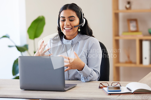 Image of Video call, laptop and seminar with a business indian woman meeting online while sitting in her office at work. Remote work, headset and communication with a female employee talking in a webinar