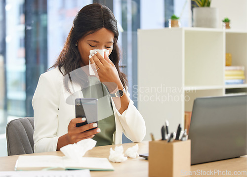 Image of Business woman, tissue and allergy while using phone and blowing nose while sick with covid or flu virus at corporate desk. Black female entrepreneur with communication app for a health consultation