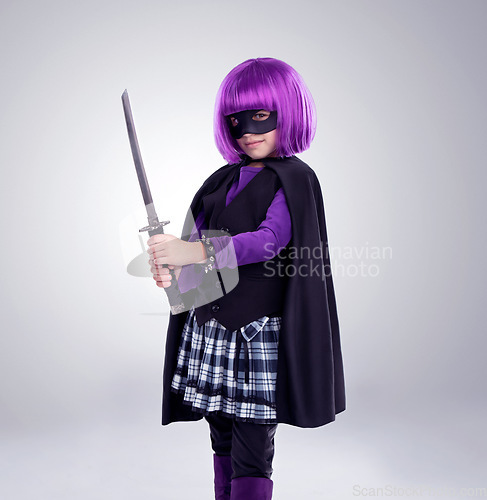 Image of Girl kid, costume and sword in studio portrait for vigilante fantasy, creative and comic aesthetic. Child, superhero mask and creativity for martial arts, villain cosplay and halloween by background