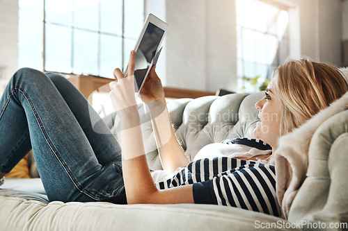 Image of Woman, tablet and credit card for ecommerce on sofa relaxing in the living room for online purchase at home. Female shopper banking on touchscreen with bank card for purchase, app or sale on couch