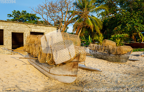 Image of traditional malagasy fishing boat with trap on beach