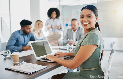 Image of Meeting, planning and portrait of a woman on a laptop typing a report, project or proposal in office. Technology, professional and female employee working on corporate strategy with team in boardroom