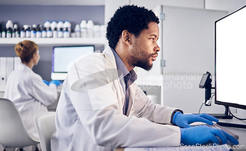 Image of African scientist man, mock up and computer in research, reading or focus for goals in lab. Black man, science or laboratory with blank desktop pc for vision, healthcare or pharmaceutical mockup