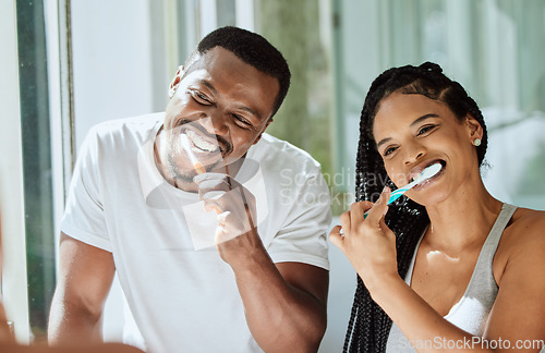 Image of Black couple, brushing teeth and dental cleaning in bathroom together for grooming hygiene, beauty wellness and healthcare with toothbrush. African man, woman and happy oral care morning routine