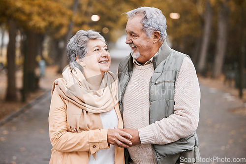 Image of Senior couple, love and hug while walking outdoor for exercise, happiness and care at a park in nature for wellness. Old man and woman together in a healthy marriage during retirement with freedom
