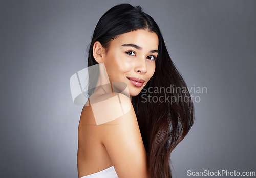 Image of Woman, hair care and beauty in studio portrait for strong, healthy natural shine and wellness by background. Model, hair glow and cosmetic self care for health, self love and confidence by backdrop