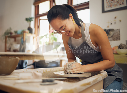 Image of Clay, happy or creative woman in workshop working on an artistic cup or mug mold in small business. Pottery project, Asian girl or Japanese designer manufacturing handicraft products as entrepreneur