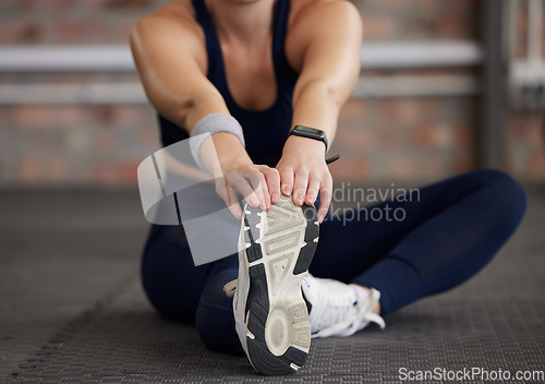 Image of Woman, legs and stretching in fitness gym for workout, training and exercise muscle pain, tension release and body healthcare wellness. Sports athlete, personal trainer and coach in warm up routine