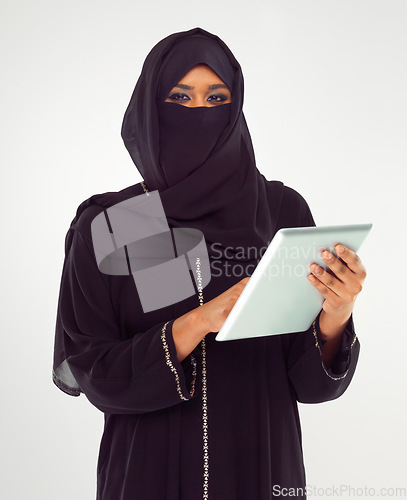 Image of Portrait, tablet and muslim with a woman in studio on a gray background browsing social media or her news feed. Islam, religion and technology with a female wearing a hijab while surfing the internet