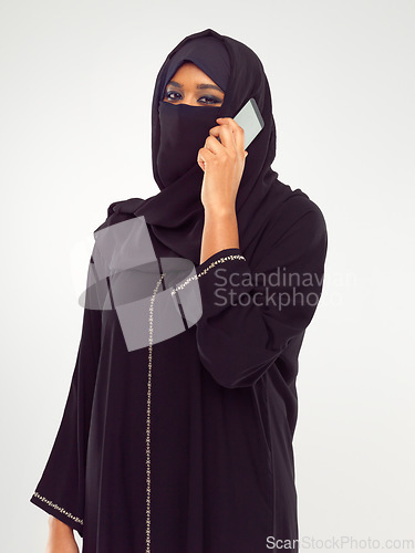 Image of Muslim woman on a phone call in studio global, international communication of culture and design. Islam, arabic and traditional model talking on smartphone for networking isolated on white background