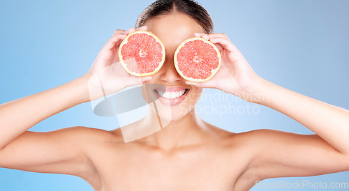 Image of Grapefruit, skincare and wellness of a woman with fruit, happiness smile or healthcare face glow. Model, happy or girl with fruits for health, cosmetic and healthy aesthetic facial beauty with food