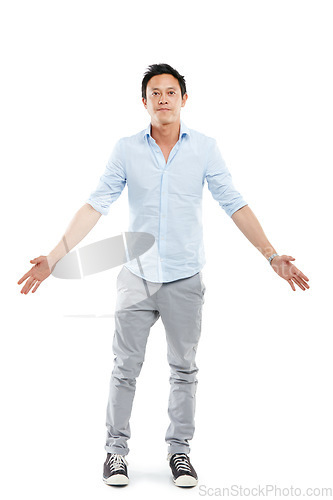 Image of Man, studio portrait and arms outstretch with fashion, sneakers and edgy jeans by white background. Isolated Asian model, hands open and palm stretching with trendy clothes, style shoes and aesthetic