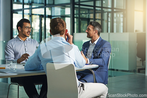 Image of Business people, meeting and discussion for corporate idea strategy, building or late at the office. Group of employee workers in business meeting, team planning or collaboration at the workplace