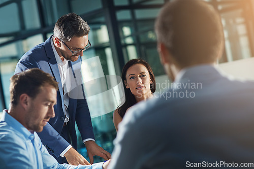 Image of Business people, meeting and talk for strategy, planning and success with teamwork, vision and leader. Businessman, leadership and group at desk with woman, man and discussion while sitting in office