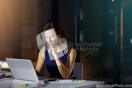 Image of Woman, laptop and thinking at office in night for planning, vision or analysis of data for mission. Corporate executive, computer and analytics for digital marketing on internet in dark modern office