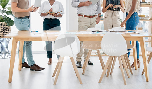 Image of Meeting, collaboration and table with a business team standing in the boardroom for strategy or planning. Corporate, teamwork and documents with a man and woman employee group in a training workshop