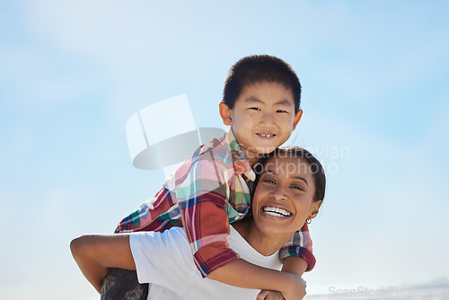 Image of Mother, beach piggyback and child in portrait, interracial family bonding and outdoor vacation in sunshine. Happy family, asian boy and black woman for adoption, love and ride game on ocean holiday