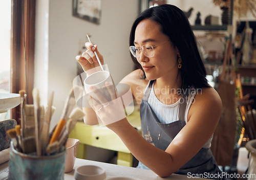Image of Asian woman, clay studio and painting design of ceramic sculpture product, creative manufacturing and workshop. Painter, pottery artist and brush mug, pattern process and production in small business