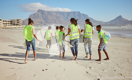 Image of Woman, children and beach clean up in school accountability learning, climate change collection or sustainability recycling. Kids, students diversity and people in community service or ocean cleaning