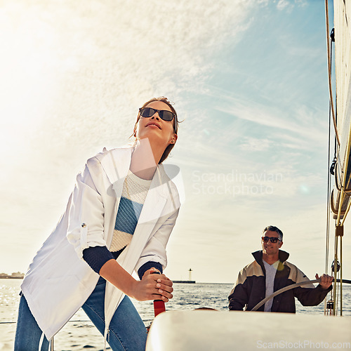 Image of Set sail. Sailing, couple and steering helm in sea travel, summer vacation and holiday adventure hobby. Yacht, cruise ship or boat direction of people on ocean or lake water with outdoor lens flare.