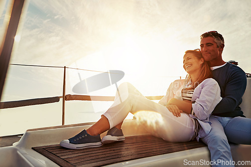 Image of Hug, sunset and couple on a yacht for travel, retirement holiday and ocean adventure in Spain. Investment, hobby and man and woman on a boat for a luxury cruise, sailing and happiness at sea