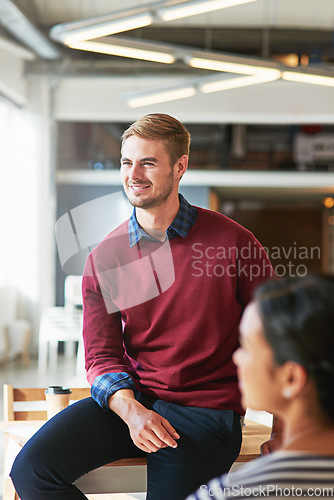 Image of Man, business people and office with focus, learning and development of career for teamwork success. Modern office, woman and coworker sitting on table for marketing, team building or conversation