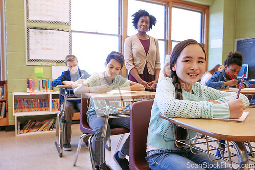 Image of Learning, teacher and portrait of a girl with a smile to study, writing and test at school. Happy, education and student at a desk for creativity in a classroom, studying notes and knowledge