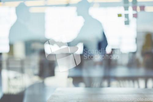 Image of Through the window, business people and handshake for corporate deal, collaboration and partnership. Glass, blurry and staff talking, coworkers and gesture for welcome, greeting and meeting in office