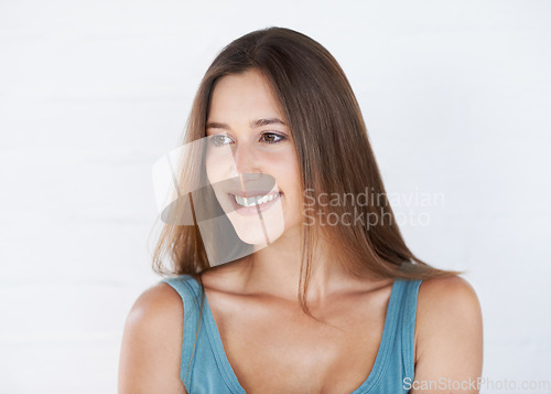 Image of Skincare, happy and woman in studio, relax and self care, treatment and grooming on grey background. Beauty, smile and girl with natural, soft and glowing skin enjoy luxury, pamper and isolated