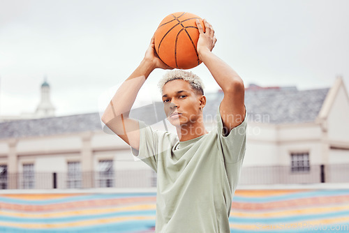 Image of Basketball, young man and basketball player with sport in park with portrait in city and exercise outdoor. Fitness, athlete on basketball court, focus and urban with sports motivation and training.