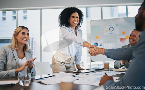 Image of Business people, woman and handshake at meeting, planning and chart on board for target, success or goal. Corporate finance group, applause and celebration for profit, promotion or vision in New York