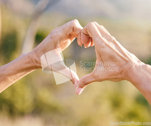 Image of Hands, heart and woman with a love symbol in nature in garden while on adventure, vacation or trip. Freedom, romance and hand romantic gesture with shape emoji in the park, forest or woods on holiday