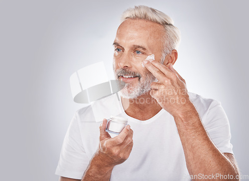 Image of Skincare, beauty and face cream on senior man on white background for spa, wellness and dermatology. Cosmetics, grooming and elderly male with anti aging beauty products, facial treatment and lotion